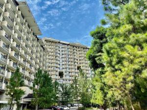 a large apartment building with trees in the foreground at Camella Northpoint condominium in Davao City