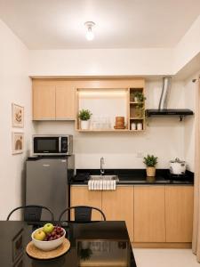 a kitchen with a bowl of fruit on a table at Camella Northpoint condominium in Davao City