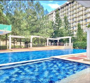 a swimming pool in front of a building at Camella Northpoint condominium in Davao City