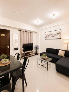 a living room with a couch and a table at Camella Northpoint condominium in Davao City