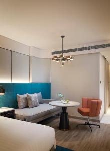 a room with a bed and a table and a couch at Amari Bangkok in Bangkok +226 photos