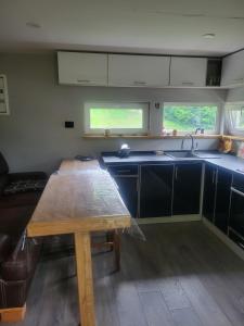 a kitchen with a wooden table and a sink at Забрус насолоди in Kosiv