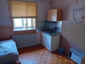 a small kitchen with a sink and a stove at Planinski dom Hermanov Hram in Log pod Mangartom