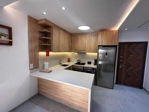 a kitchen with wooden cabinets and a white counter top at la perle d'el jadida in El Jadida