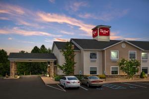 a coca cola building with cars parked in a parking lot at Red Roof Inn Charlestown in Charlestown