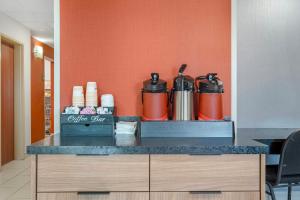 a counter with two kettles on top of it at Red Roof Inn Charlestown in Charlestown +27 photos
