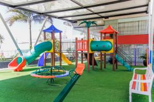 a playground with different colored playground equipment in a building at Trade Hotel in Juiz de Fora