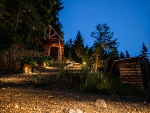 a house with lights in front of it at night at Mornov raj in Vuzenica
