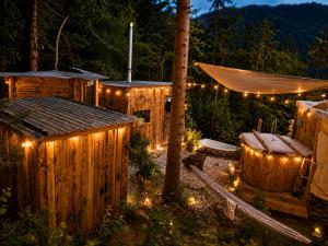 a backyard with a hot tub and a fence with lights at Mornov raj in Vuzenica