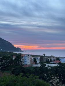 a view of a city with a sunset in the background at el sahel residence in Beni Haoua