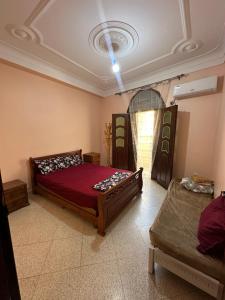 a bedroom with a bed and two sets of bunk beds at el sahel residence in Beni Haoua