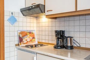 a kitchen with a counter top with a blender at Appartementhaus Holmernhof I in Bad Füssing