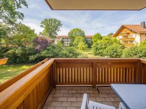 a balcony with a wooden fence and a table at Appartementhaus Holmernhof I in Bad Füssing +34 photos