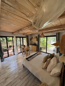 a bedroom with a large bed in a room with windows at LA PAUSE Chisà in Chisa +67 photos