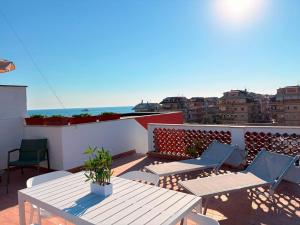 a balcony with a table and chairs and the ocean at Mare di Roma 2 in Lido di Ostia
