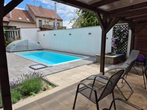 a patio with a swimming pool and chairs at Friendly house in Bořetice in Bořetice