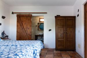 a bedroom with a bed and a wooden door at Tabaiba Suites Lanzarote - Macaronesia Homes in La Asomada