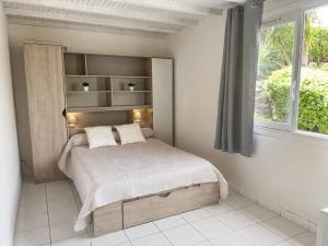 a bedroom with a large bed with a window at Hôtel Saint Jacques in Sorède +39 photos
