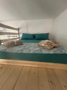 a large bed with blue pillows on top of it at Ciemme Apartments in Castellammare di Stabia