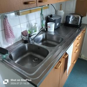 a kitchen counter with a sink in a kitchen at Retro House in Savonlinna +18 photos