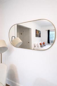 a mirror on a white wall in a room at Downtown High Falls Studio Apt, Kitchen, TV in Rochester +4 photos