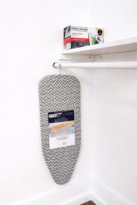a tie hanging on a shelf with books at Downtown High Falls Studio Apt, Kitchen, TV in Rochester