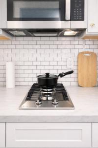 a pot on a stove top in a kitchen at Downtown High Falls Studio Apt, Kitchen, TV in Rochester