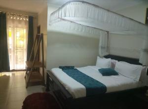 a bedroom with a large bed with a canopy at SolBlu Cottages in Kira
