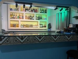 a bar with a lot of bottles on the wall at SolBlu Cottages in Kira +2 photos