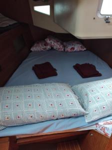a bed with two pillows on top of it at Boat Experience Holiday26 in La Spezia