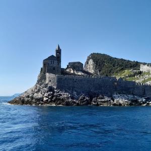 a castle on an island in the water at Boat Experience Holiday26 in La Spezia