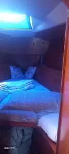 a bed in a room with a light on at Boat Experience Holiday26 in La Spezia +14 photos