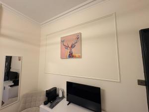 a living room with a flat screen tv on a wall at 'Maisie' in ApartNest Auchterarder in Auchterarder