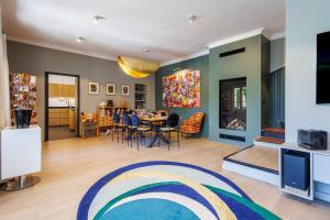 a living room with a table and a dining room at Villa du Val - Welkeys in Aix-en-Provence +13 photos