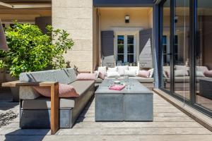 a patio with a couch and a coffee table at Villa du Val - Welkeys in Aix-en-Provence