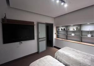 a bedroom with a large flat screen tv on the wall at Lomar suite 2 - Depto céntrico Villa María in Villa María
