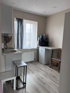 a small kitchen with a sink and a table at Straumes apartamenti in Valmiera