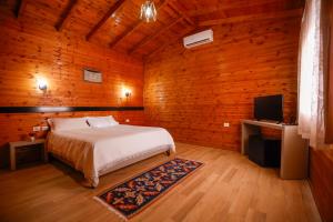 a bedroom with a bed and a flat screen tv at Agroturizem Bylis in Hekal +142 photos