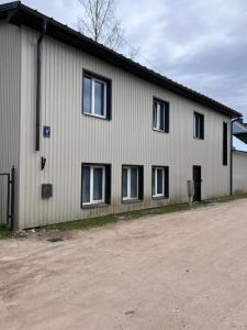 a white building with windows on the side of it at Straumes apartamenti in Valmiera