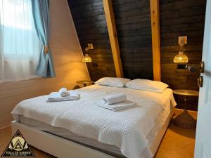 ein Schlafzimmer mit einem Bett, auf dem Handtücher liegen in der Unterkunft Garden Hotel in Kutaissi