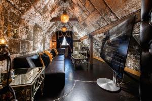a room with a couch and a table in a building at Crazy Bear Beaconsfield in Beaconsfield