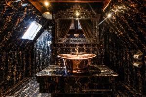 a bathroom with a sink and a mirror at Crazy Bear Beaconsfield in Beaconsfield +17 photos