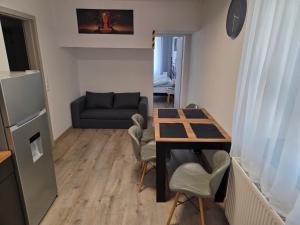 a small living room with a table and a couch at Apartment Linde in Bubesheim