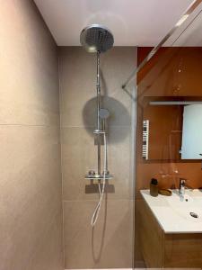 a shower in a bathroom with a sink at La Villa d'Aix - Entre lacs et montagne - Jacuzzi in Saint-Ours +55 photos