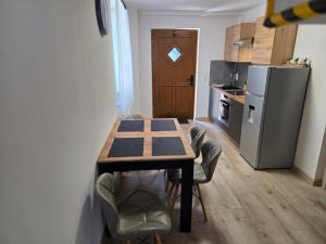 a kitchen with a table and chairs and a refrigerator at Apartment Linde in Bubesheim +9 photos