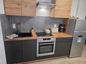 a kitchen with a sink and a stove top oven at Apartment Linde in Bubesheim