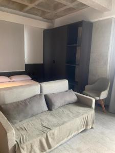 a room with a couch and a bed and a chair at FLAT Executivo próx Consulado Americano in Recife +24 photos