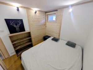 a bedroom with a bed in a small room at Nice chaleett in mountains in Saint-Martin-de-Belleville