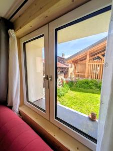 a window in a tiny house looking out at a yard at Nice chaleett in mountains in Saint-Martin-de-Belleville