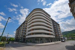 a large building on the side of a street at NOVA Olimpia Residence - Free Garage in Sarajevo